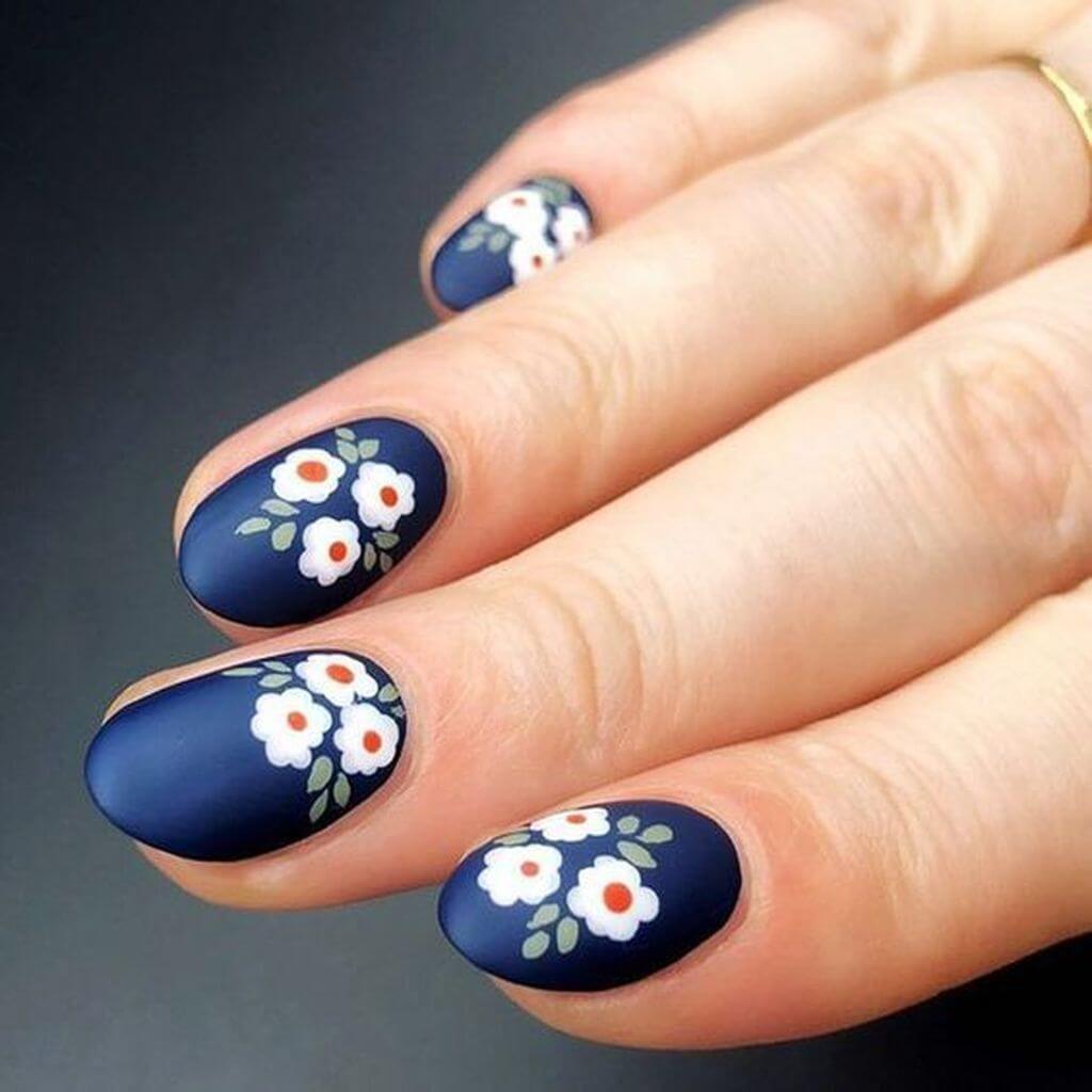 uñas con flores sobre base azul